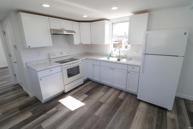 kitchen with under cabinet range hood, white appliances, a sink, white cabinetry, and dark wood finished floors