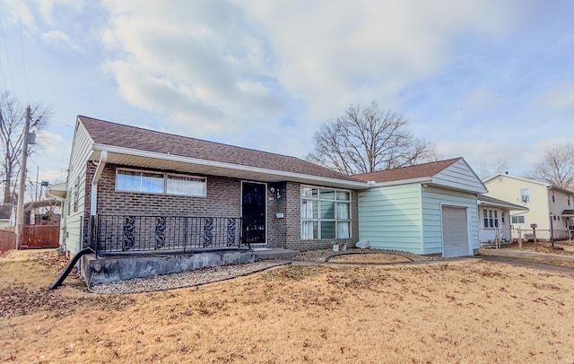 ranch-style home featuring a garage, brick siding, and driveway