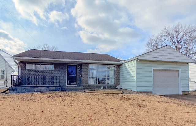 ranch-style home with brick siding, roof with shingles, and an attached garage