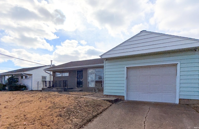 single story home with a garage and concrete driveway