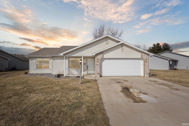 single story home with brick siding, a yard, a porch, concrete driveway, and an attached garage