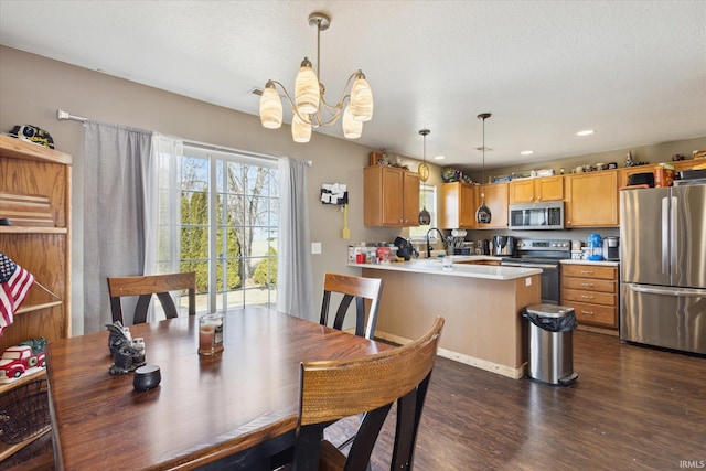 dining area with a textured ceiling, dark wood-type flooring, and recessed lighting