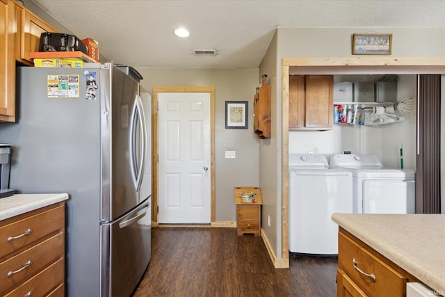 interior space featuring visible vents, brown cabinets, separate washer and dryer, and freestanding refrigerator