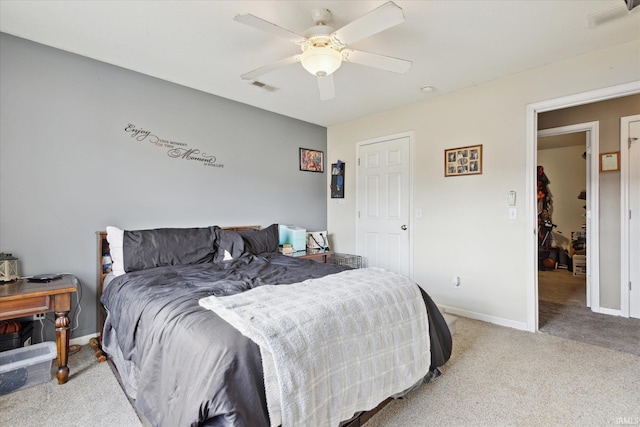 bedroom featuring light carpet, baseboards, visible vents, and a ceiling fan