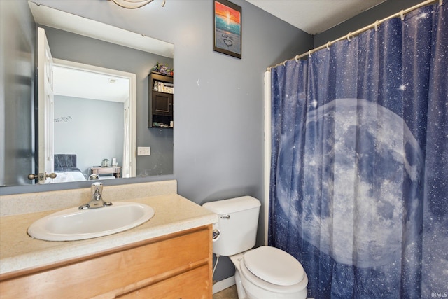 ensuite bathroom with vanity, toilet, and ensuite bathroom