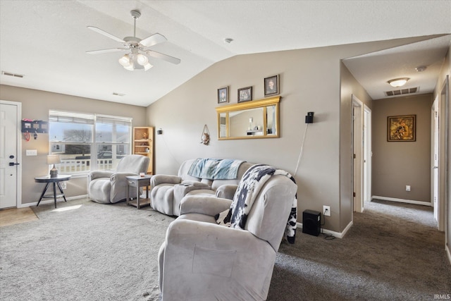 carpeted living area with baseboards, visible vents, vaulted ceiling, and a ceiling fan