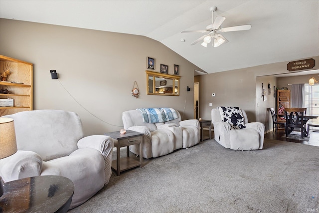 living room featuring lofted ceiling, ceiling fan, and carpet