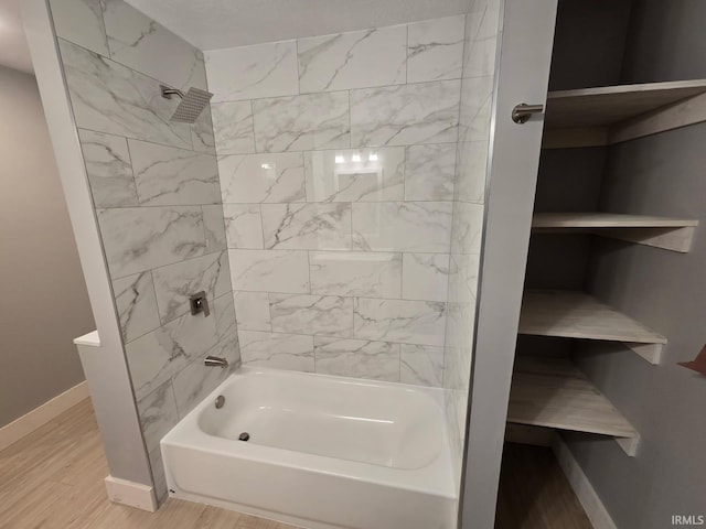 full bath featuring shower / bathing tub combination, baseboards, and wood finished floors