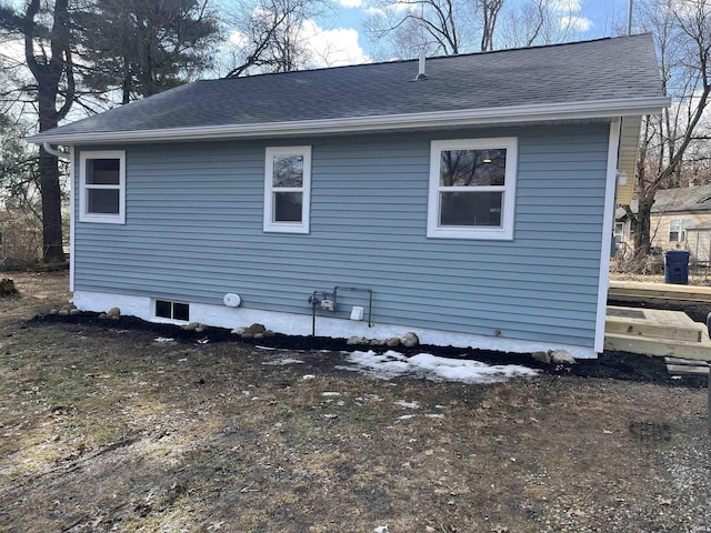 view of home's exterior with roof with shingles