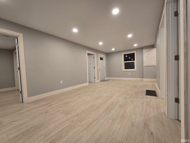 below grade area featuring recessed lighting, baseboards, visible vents, and light wood finished floors