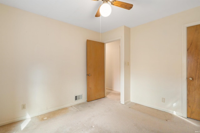 interior space with carpet, visible vents, ceiling fan, and baseboards