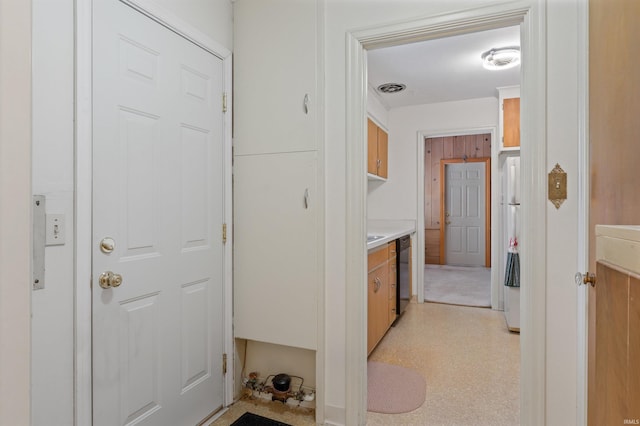 hallway with visible vents and light floors