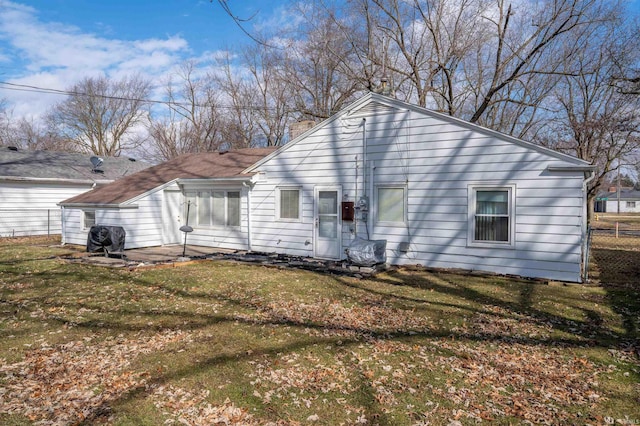 view of front of home with a front yard and fence