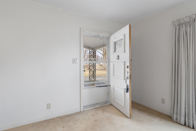 empty room with light colored carpet and baseboards