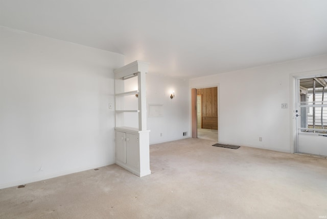 unfurnished room with light carpet