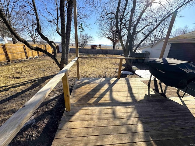 wooden terrace featuring a fenced backyard