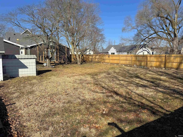 view of yard with a fenced backyard and an outdoor structure