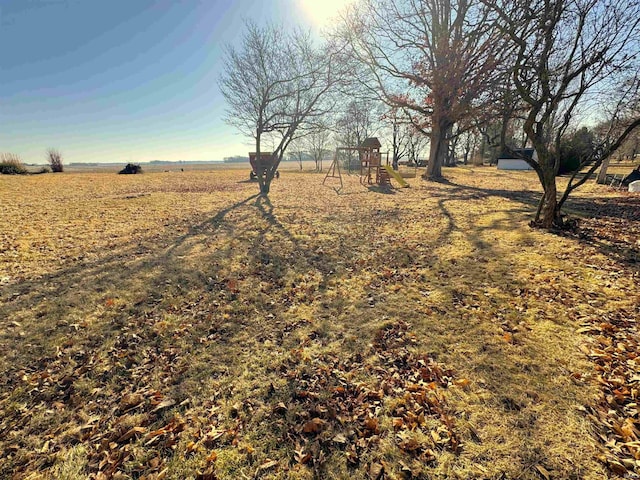 view of yard featuring a rural view and a playground