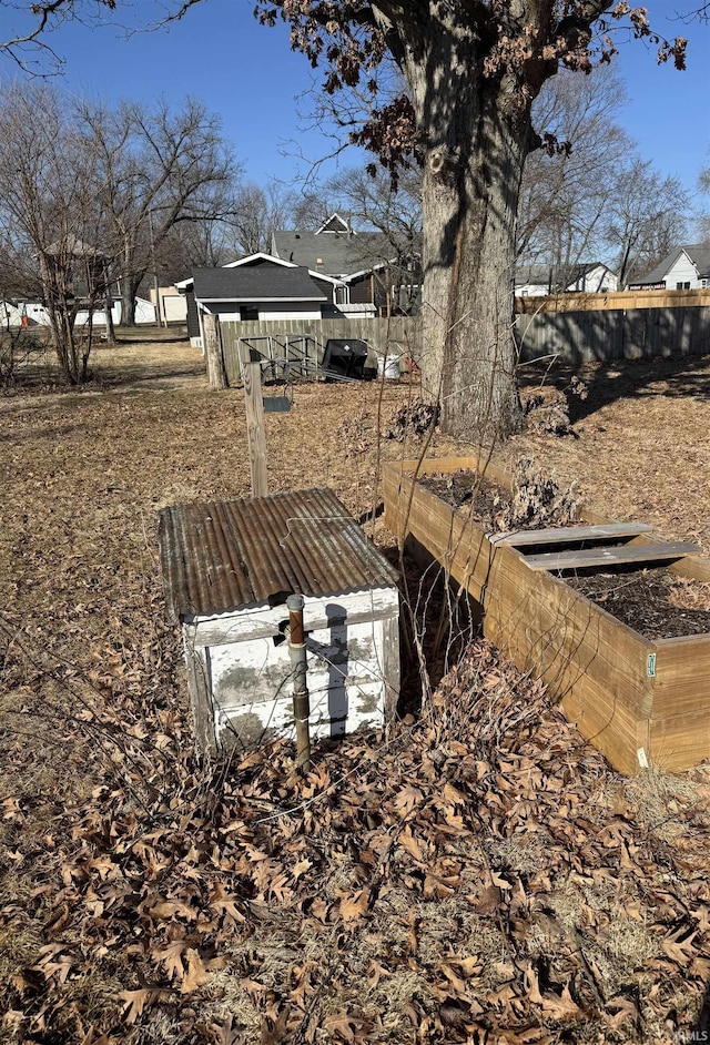 view of yard with a vegetable garden and fence