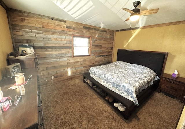 bedroom featuring ceiling fan, carpet floors, and wood walls