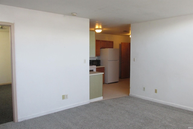 empty room with light carpet and baseboards