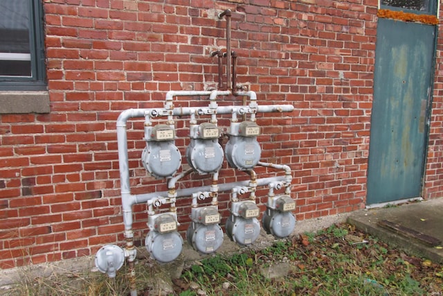 details featuring gas meter and brick siding