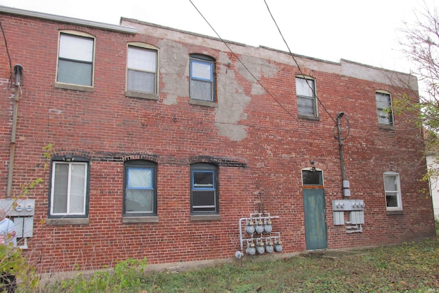 view of property exterior with brick siding