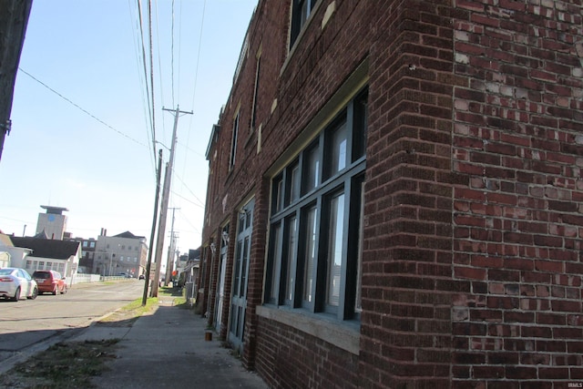 view of side of property featuring brick siding