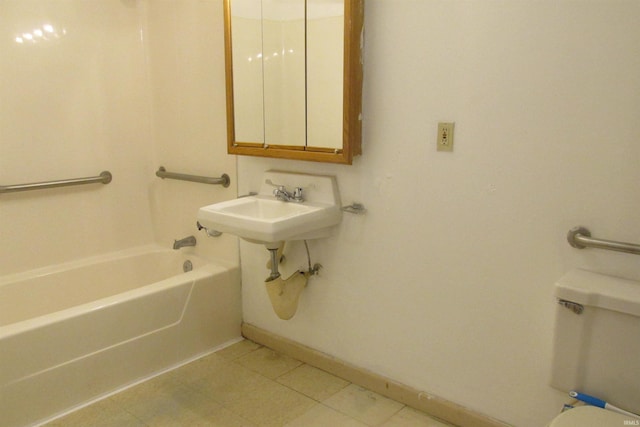 bathroom with tile patterned flooring, baseboards, a sink, and toilet