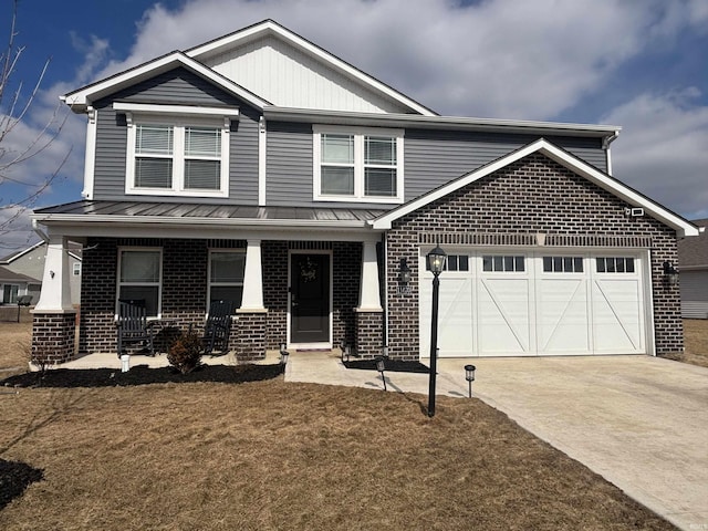 craftsman-style home with driveway, an attached garage, covered porch, a standing seam roof, and brick siding