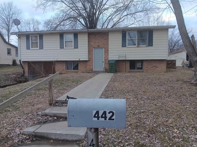 split foyer home featuring brick siding