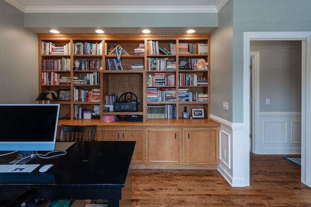 office with crown molding, built in features, wood finished floors, and wainscoting