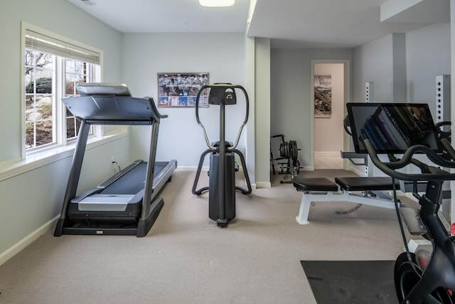 exercise room with carpet and baseboards