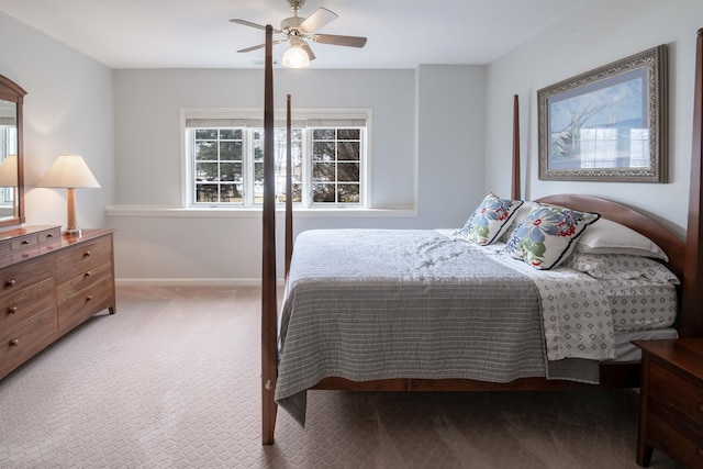 bedroom with a ceiling fan, baseboards, and carpet flooring