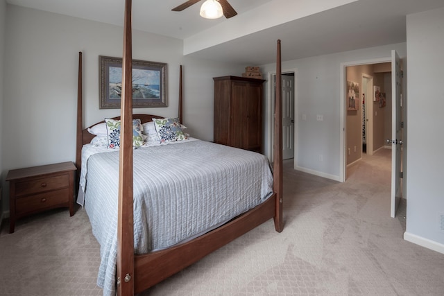 bedroom with a ceiling fan, light colored carpet, and baseboards