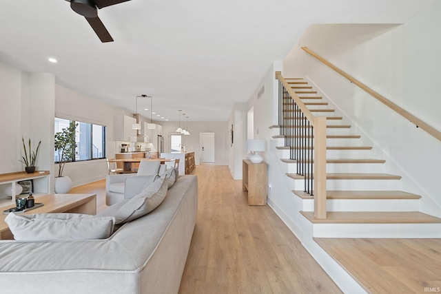 living area featuring light wood finished floors, recessed lighting, visible vents, stairway, and a ceiling fan