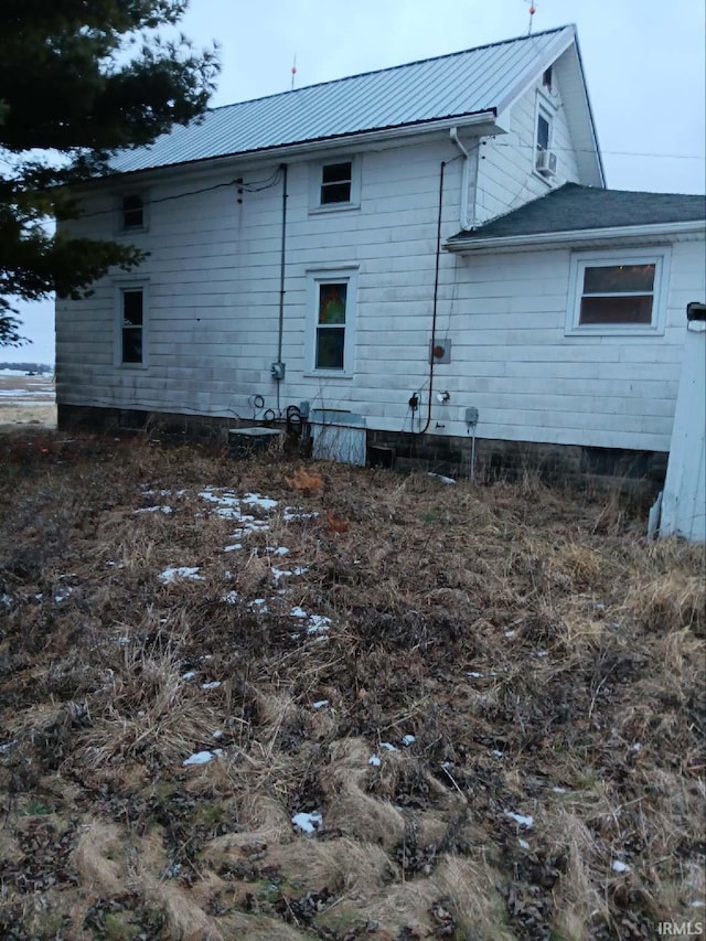 view of side of home with metal roof