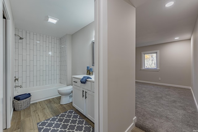 bathroom with toilet, recessed lighting, vanity, baseboards, and tub / shower combination