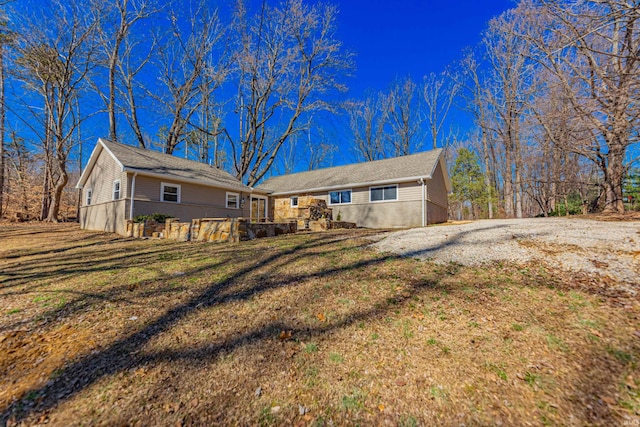 rear view of property featuring a yard