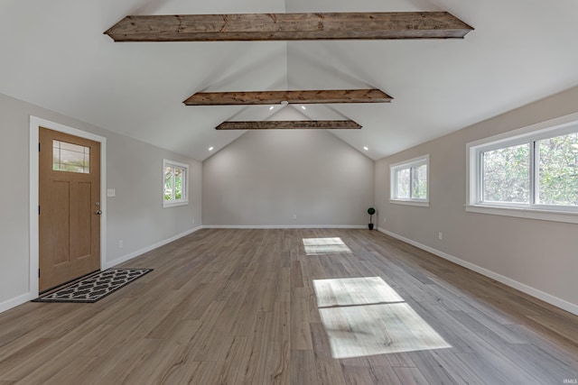 foyer entrance with vaulted ceiling with beams, baseboards, and wood finished floors