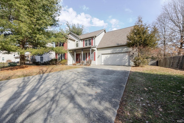 view of front facade featuring a garage, driveway, covered porch, fence, and a front lawn