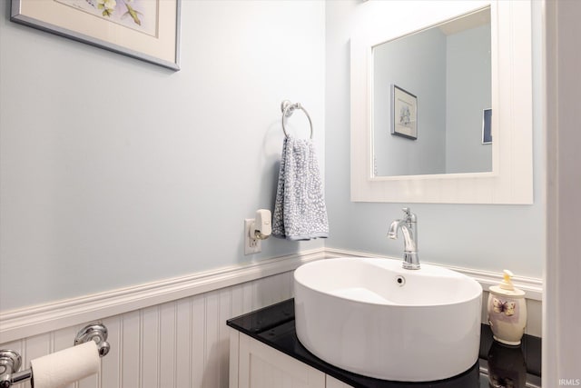 bathroom with vanity and wainscoting