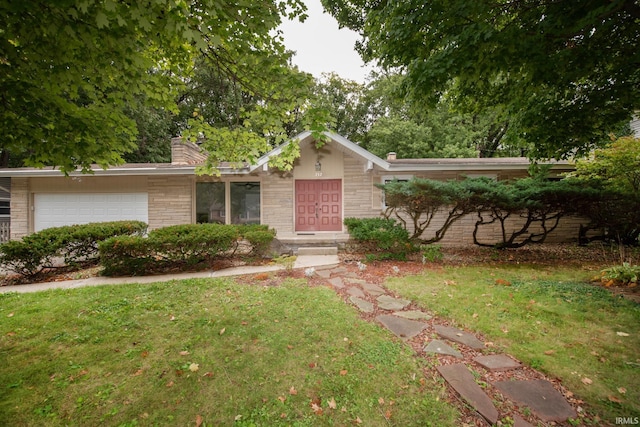 single story home featuring brick siding, a chimney, a front yard, a garage, and stone siding