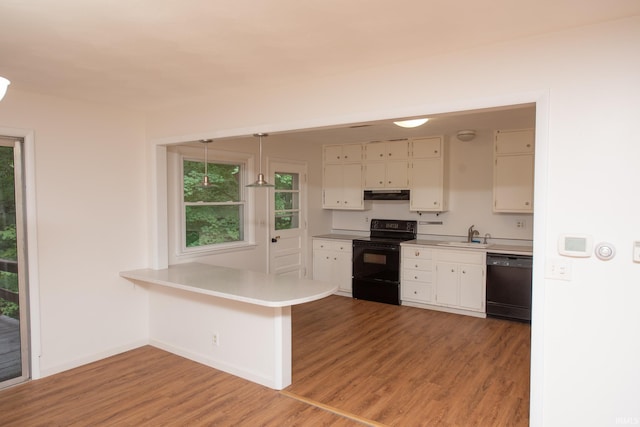 kitchen with black appliances, light wood-type flooring, light countertops, and white cabinetry