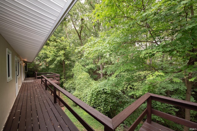 wooden deck featuring a forest view