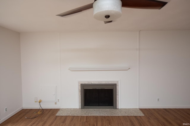 interior details featuring a fireplace, wood finished floors, and baseboards