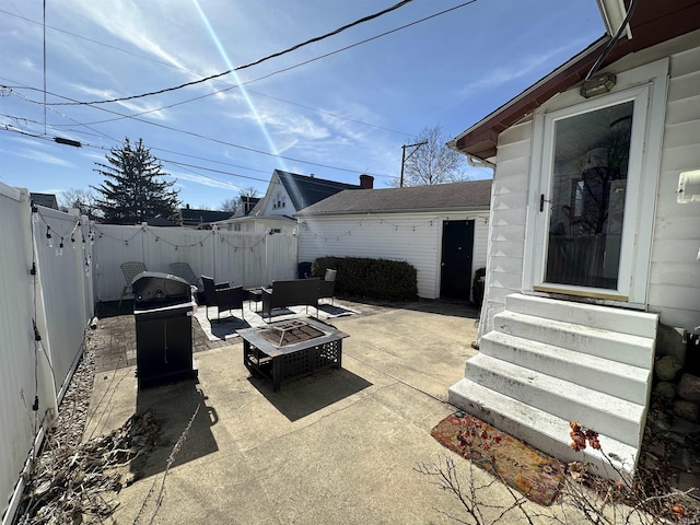 view of patio with entry steps, an outdoor fire pit, and a fenced backyard