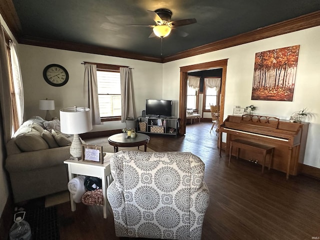 living area with dark wood finished floors, a wealth of natural light, and crown molding