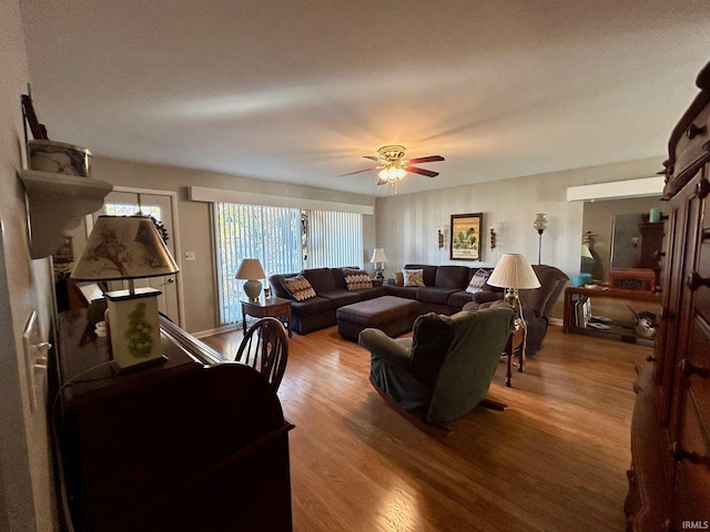 living room with a ceiling fan and wood finished floors