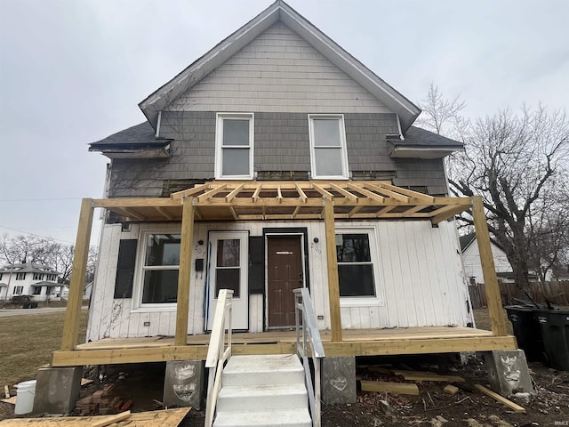 view of front of home with a shingled roof